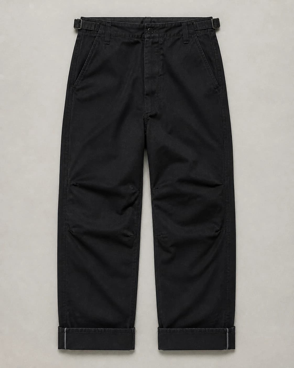 Close study of black trousers with turned cuffs